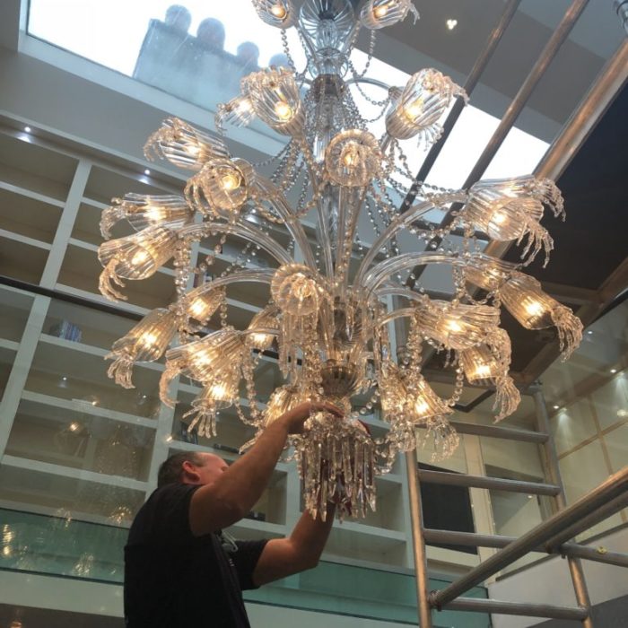 a member of the elite team giving a london chandelier clean her full attention | chandelier cleaning in kent
